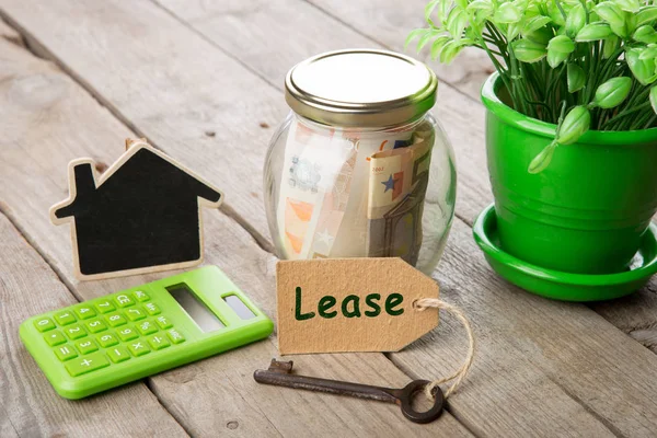 Real estate finance concept - money glass with Lease word