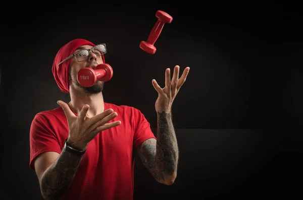 guy in a red hat and t-shirt posing on a black background