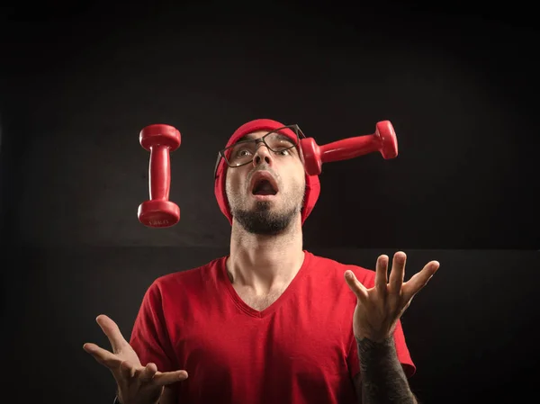 guy in a red hat and t-shirt posing on a black background