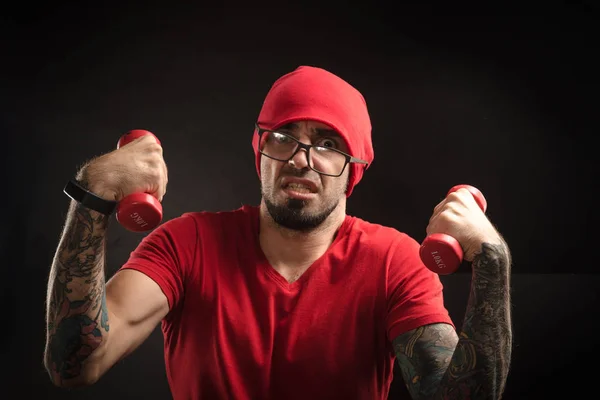 guy in a red hat and t-shirt posing on a black background