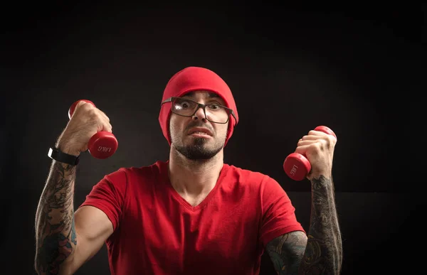 guy in a red hat and t-shirt posing on a black background