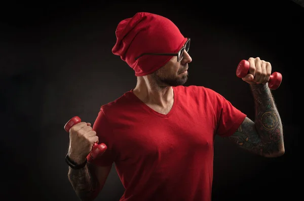 guy in a red hat and t-shirt posing on a black background