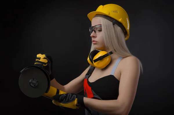 the girl in a construction firm works with a tape measure