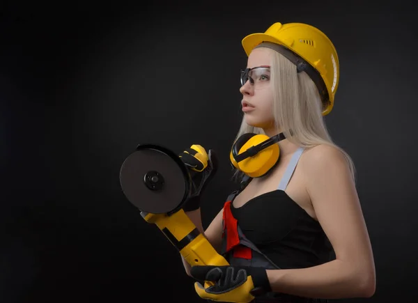 the girl in a construction firm works with a tape measure