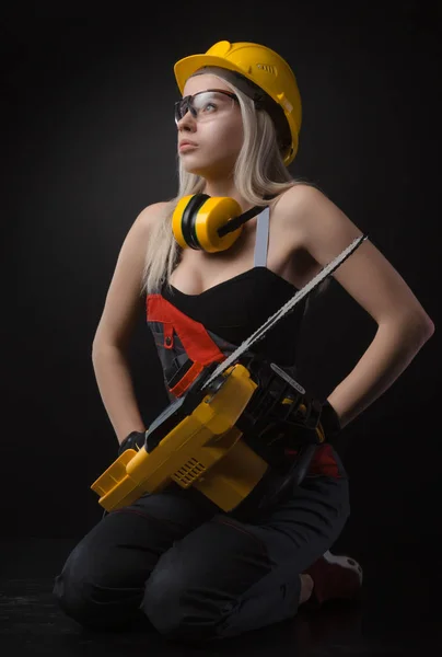 Menina Loira Macacão Posando Com Uma Serra Elétrica — Fotografia de Stock