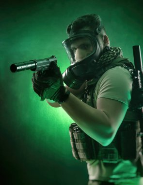 sevdanın karanlık bir arka plan üzerinde elinde bir silahla poz askeri özel giysili adam