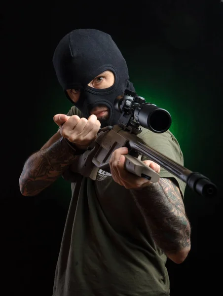 El tipo con ropa protectora y una máscara negra con un rifle de francotirador —  Fotos de Stock