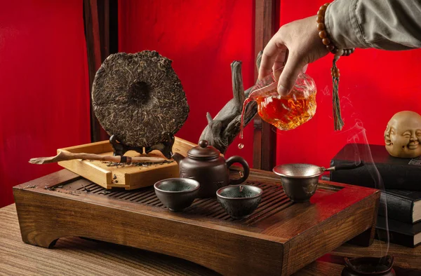 Tea table with instruments teapots cups pancake and tea Shen Puer — Stock Photo, Image