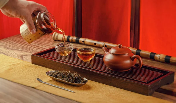 Tea table with instruments teapots cups pancake and tea Shen Puer — Stock Photo, Image