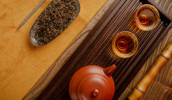 Tea table with instruments teapots cups pancake and tea Shen Puer — Stock Photo, Image