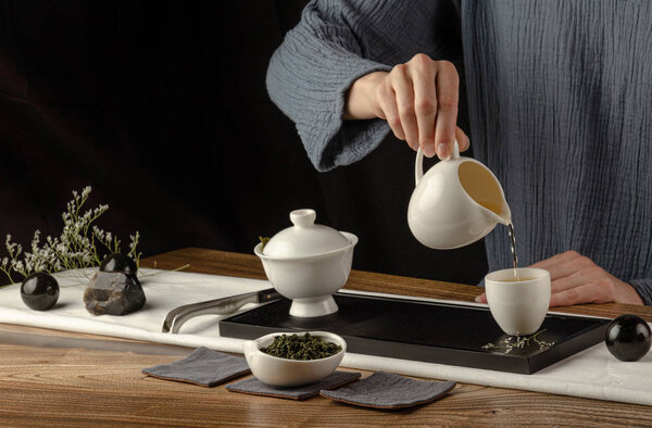 tea table with instruments teapots cups pancake and tea Shen Puer