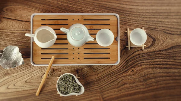 The tea table with instruments teapots cups and green tea — Stock Photo, Image