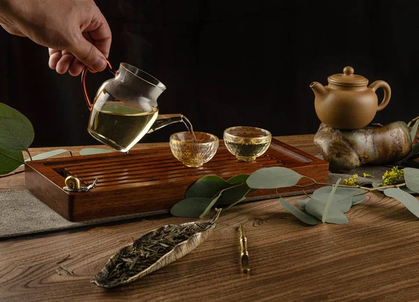 Tea table with instruments teapots cups and tea Shen Puer — Stock Photo, Image