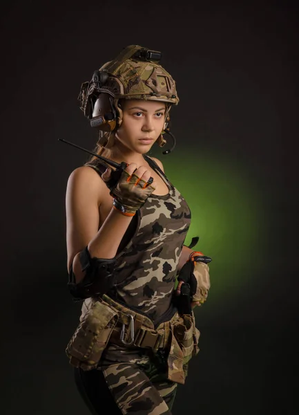 A girl in a military uniform helmet says on the radio — Stock Photo, Image