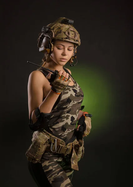 Een meisje in een militaire uniform helm zegt op de radio — Stockfoto
