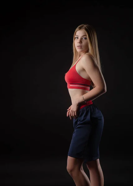 Athletic girl in Boxing shorts on a black background — Stock Photo, Image