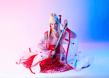 Katana ile geyşa gibi giyinmiş bir kadın.