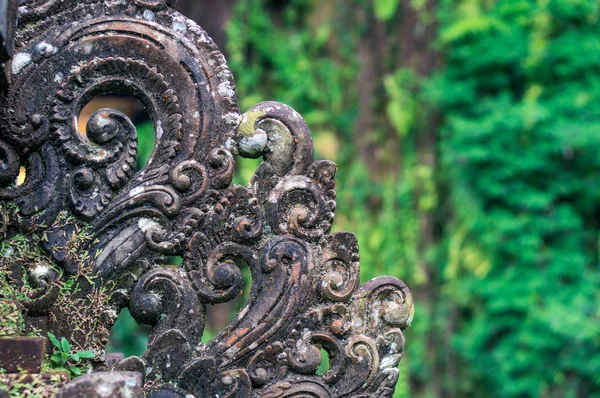 Ornate decoration carved from the stone on the green natural background