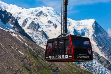 CHAMONIX, FRANCE - JULY 18, 2019: Cable car coach going to the Aiguille du Midi 3842 m mountain in the Mont Blanc massif in the French Alps near the Chamonix town in France clipart