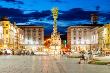 Holy Trinity column on the Hauptplatz or main square in the centre of Linz in Austria at sunset. Linz is the third largest city of Austria. clipart