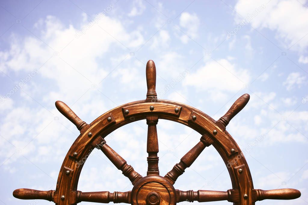 Old Vintage Wooden Helm Wheel on sea background