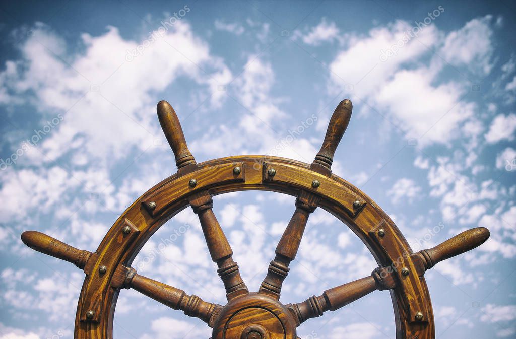 Old Vintage Wooden Helm Wheel on sea background