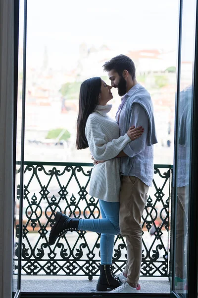 Young couple relaxing at the balcony of their new house.