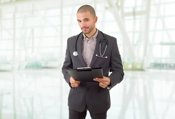 male doctor thinking with his notes, at the hospital