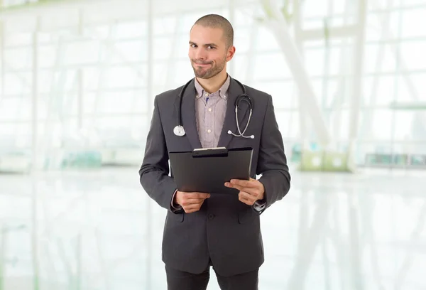 male doctor thinking with his notes, at the hospital