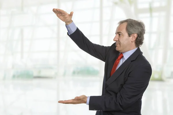 Friendly Mature Businessman Presenting Something Office — Stock Photo, Image