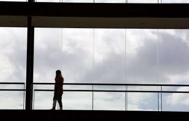 Modern ofis binasındaki panoramik pencereli bir iş adamının silüeti..
