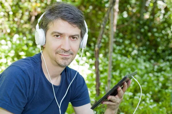 Young Man Relaxing Tablet Listening Music Headphones Park Outdoor — Stock Photo, Image