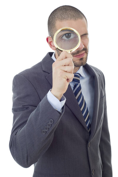 Isolated young business man with magnifying glass