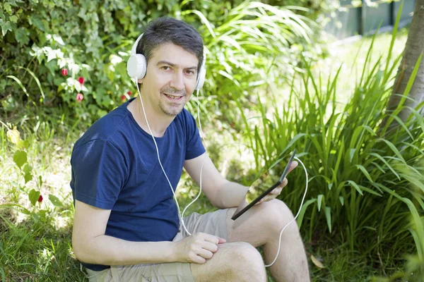 Young Man Relaxing Tablet Listening Music Headphones Park Outdoor — Stock Photo, Image