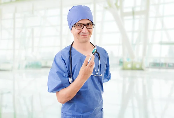 Happy male doctor with a syringe, at the hosiptal — Stock Photo, Image