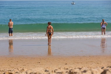VILA DO BISPO, PORTUGAL: Vila do Bispo 'daki ünlü Salema plajında insanlar. Bu plaj Algarve 'nin ünlü turistik bölgesinin bir parçasıdır..