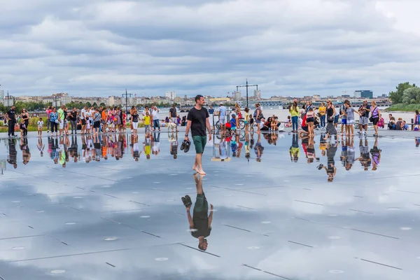 BORDEAUX, FRANCE: The Famous Bordeaux water mirror full of people having fun in the water, in Bordeaux, France.