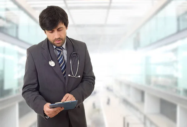 male doctor thinking with his notes, at the hospital