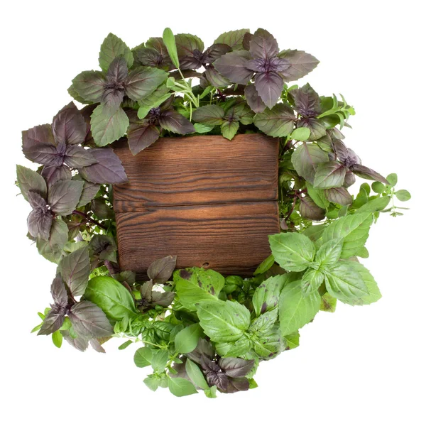 Wooden burnt board over various sweet basil herb leaves backgrou — Stock Photo, Image