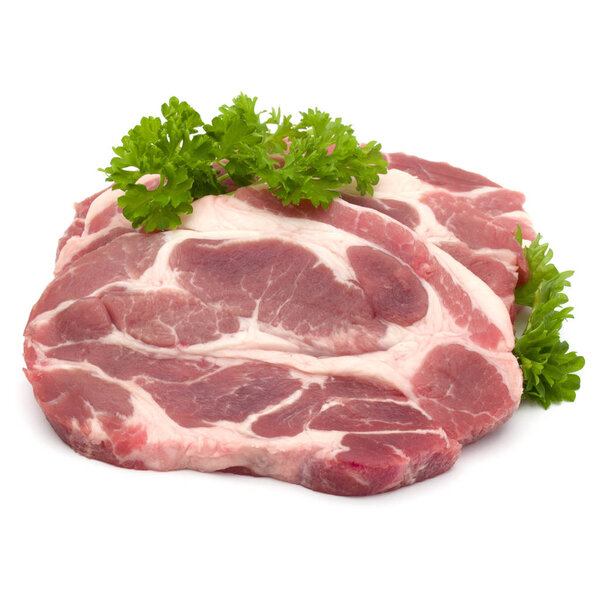 Raw pork neck chop meat with parsley herb leaves garnish isolate