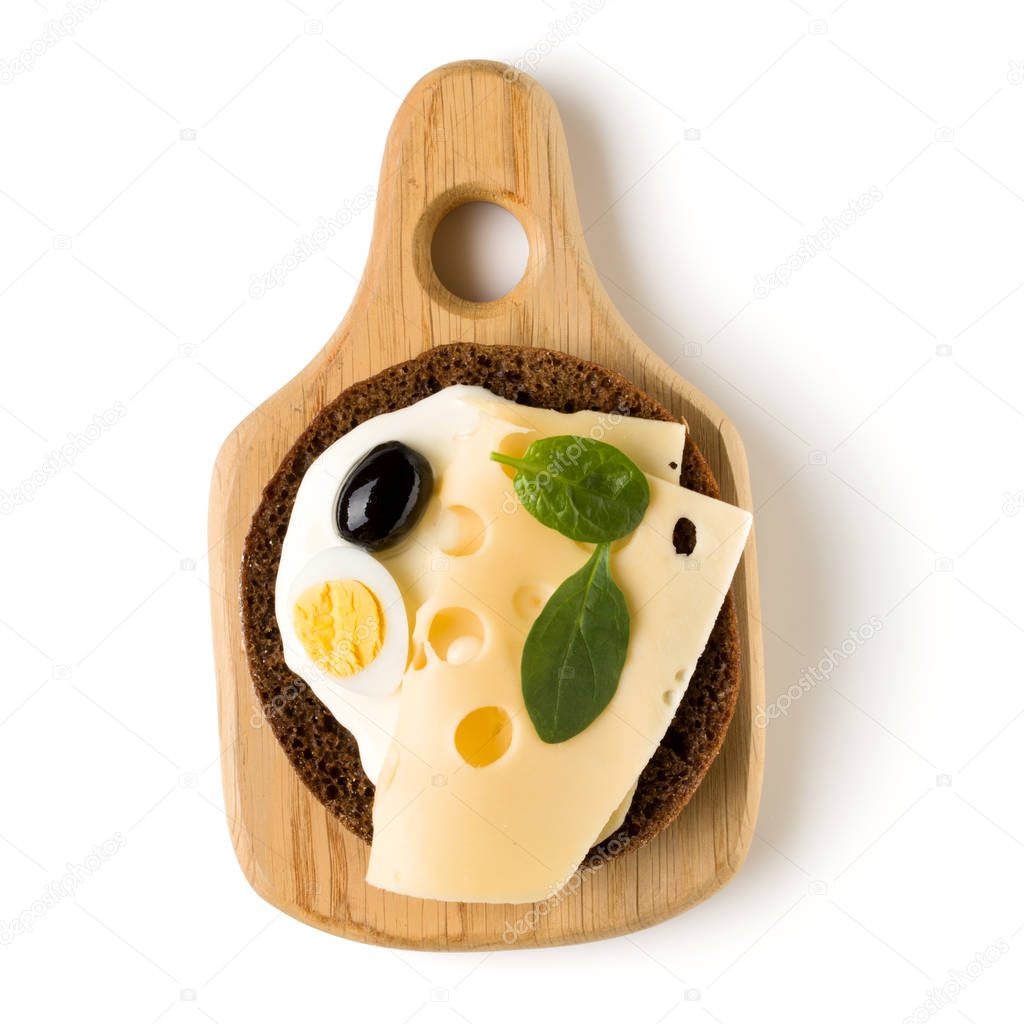 Open  faced cheese sandwich canape or crostini on a wooden serving board  isolated on white background closeup. Top view. Vegetarian tartarine.