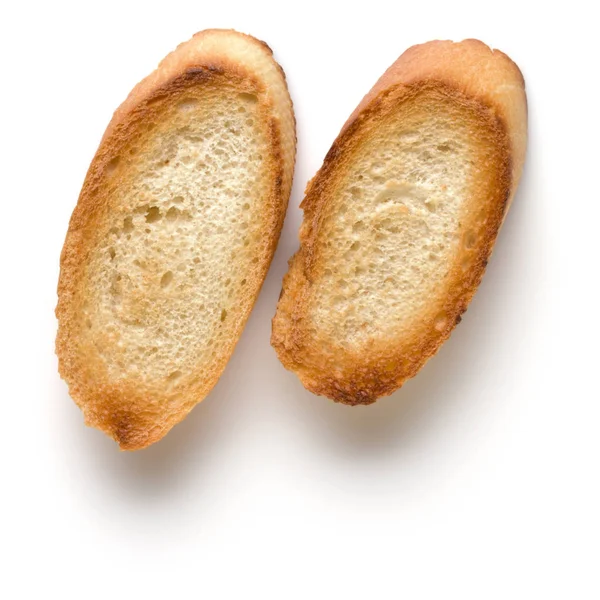 在白色背景上被隔离的烤面包片近了 克劳顿 顶视图 — 图库照片