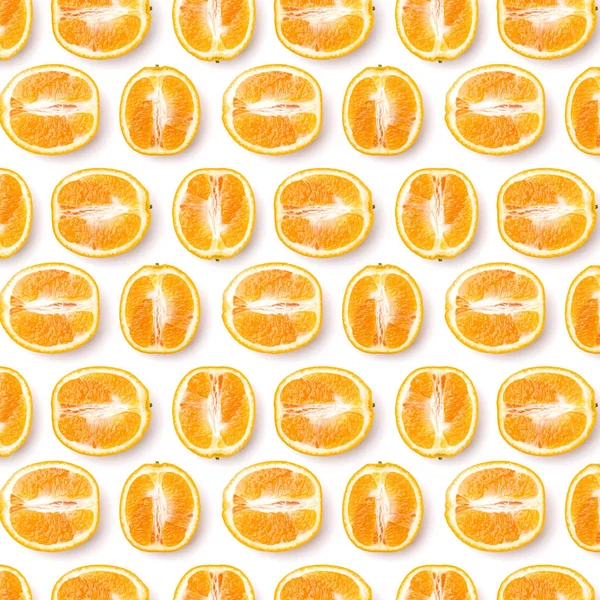 pattern of orange fruit halves. Orange fruit isolated on white background. Food background. Flat lay, top view.