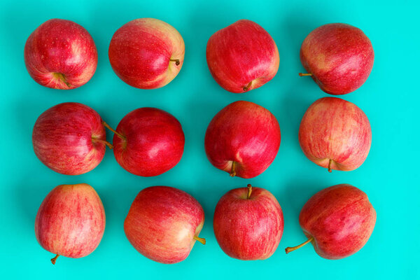 Fruit pattern of red apple on blue background. Flat lay, top view. Pop art design, creative summer concept. Food background.