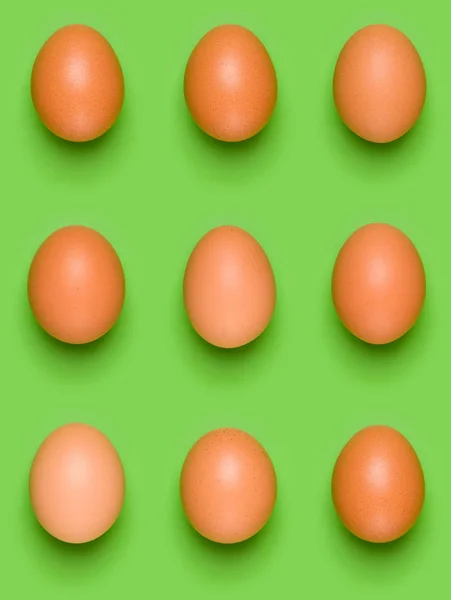 Eggs pattern on green background. Easter concept. Flat lay, top view. Food background.