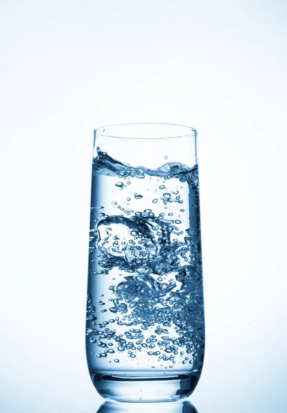 Water glass on blue background — Stock Photo, Image