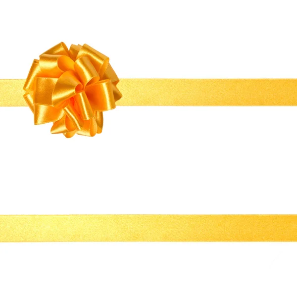 Świąteczny prezent złote wstążki i łuk na białym tle — Zdjęcie stockowe
