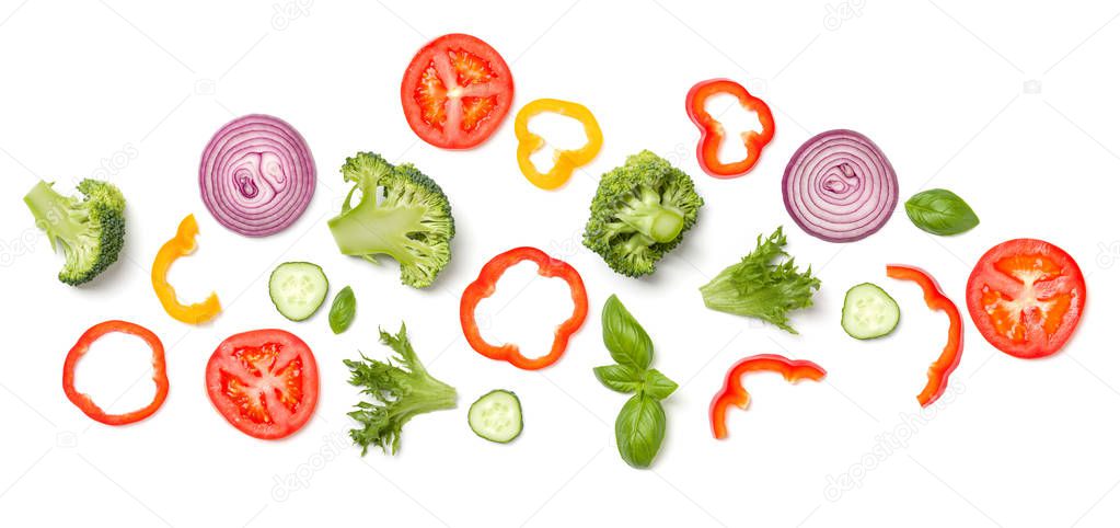 Creative layout made of tomato slice, onion, cucumber, basil lea