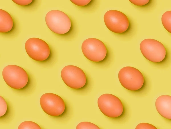 Eggs pattern on yellow background. Easter concept. Flat lay, top