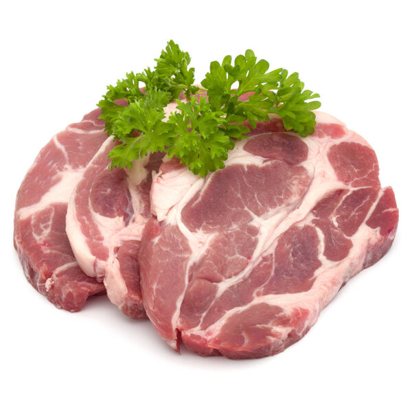 Raw pork neck chop meat with parsley herb leaves garnish isolate